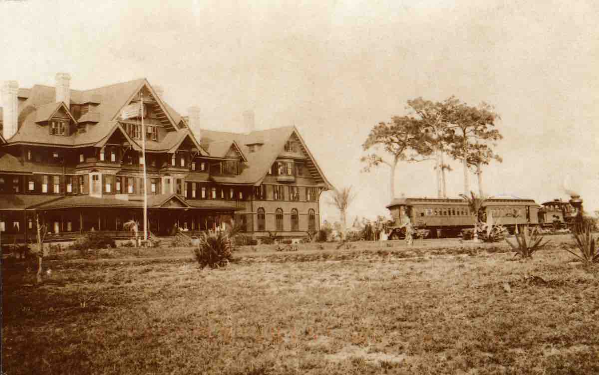 a large house with a train in the background