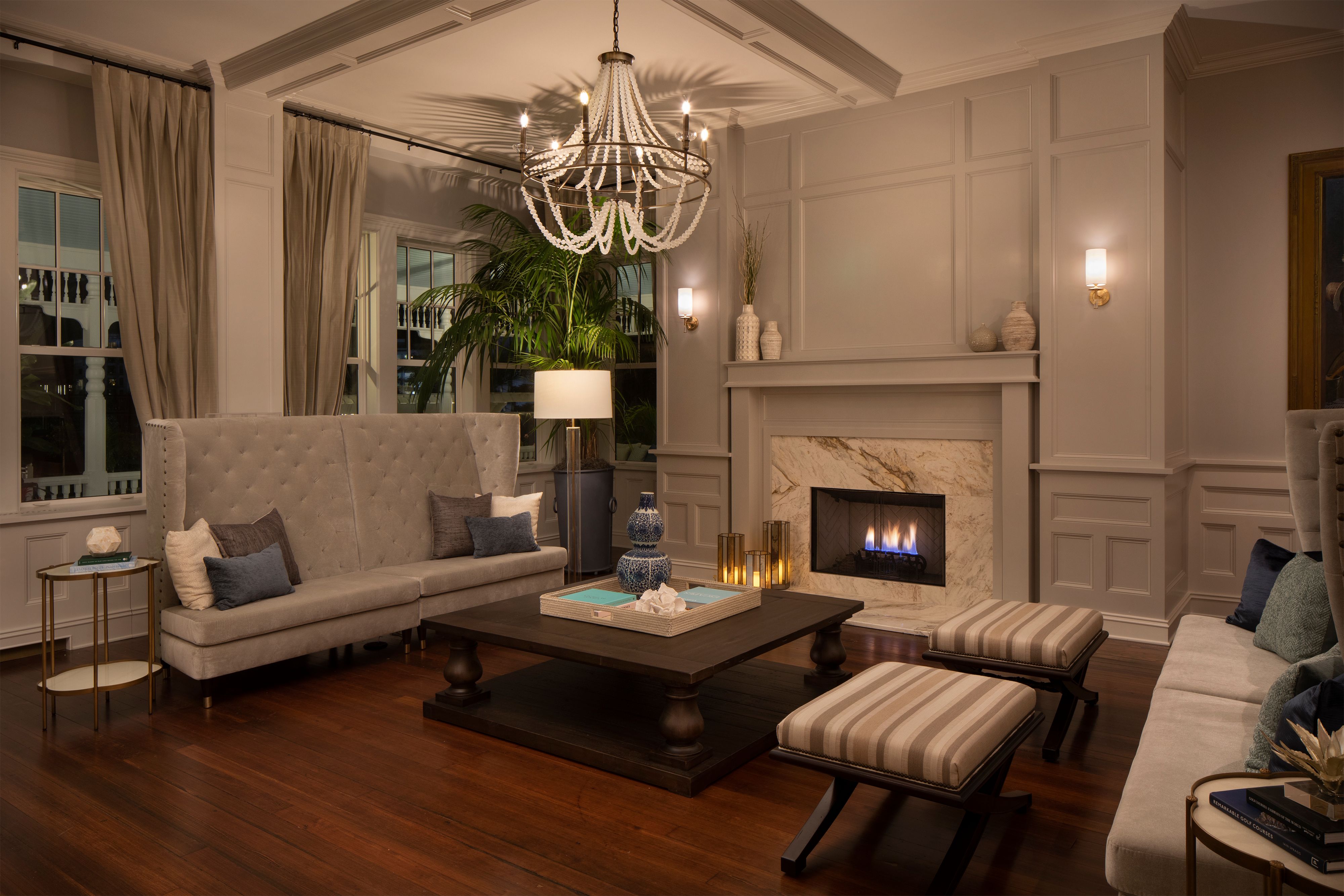 a living room with a chandelier and a fireplace