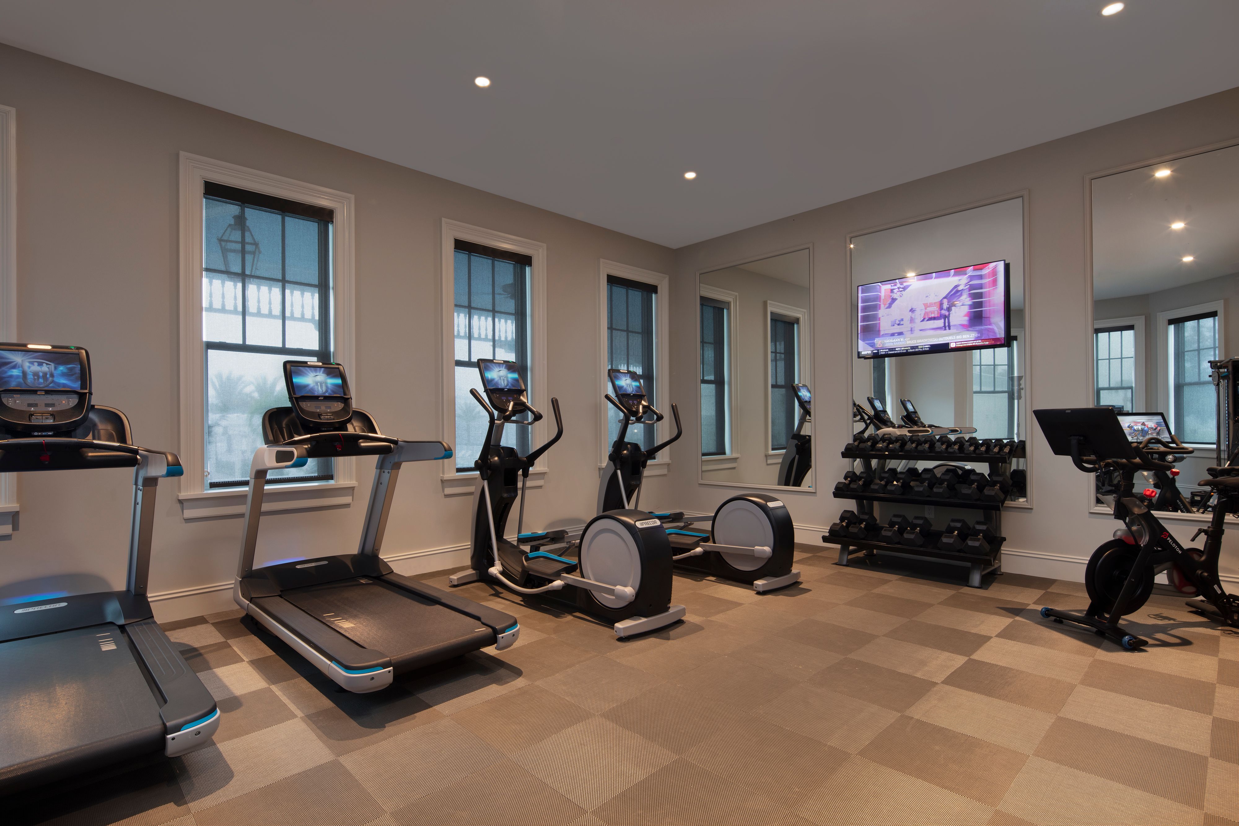 a room with exercise equipment and a television