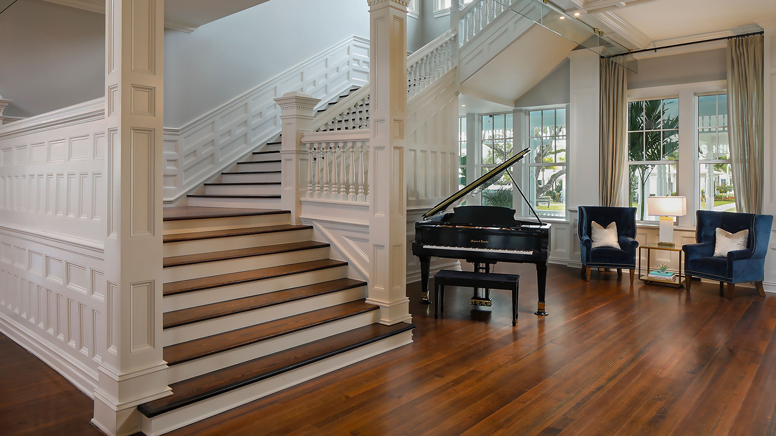 a piano in a room with stairs