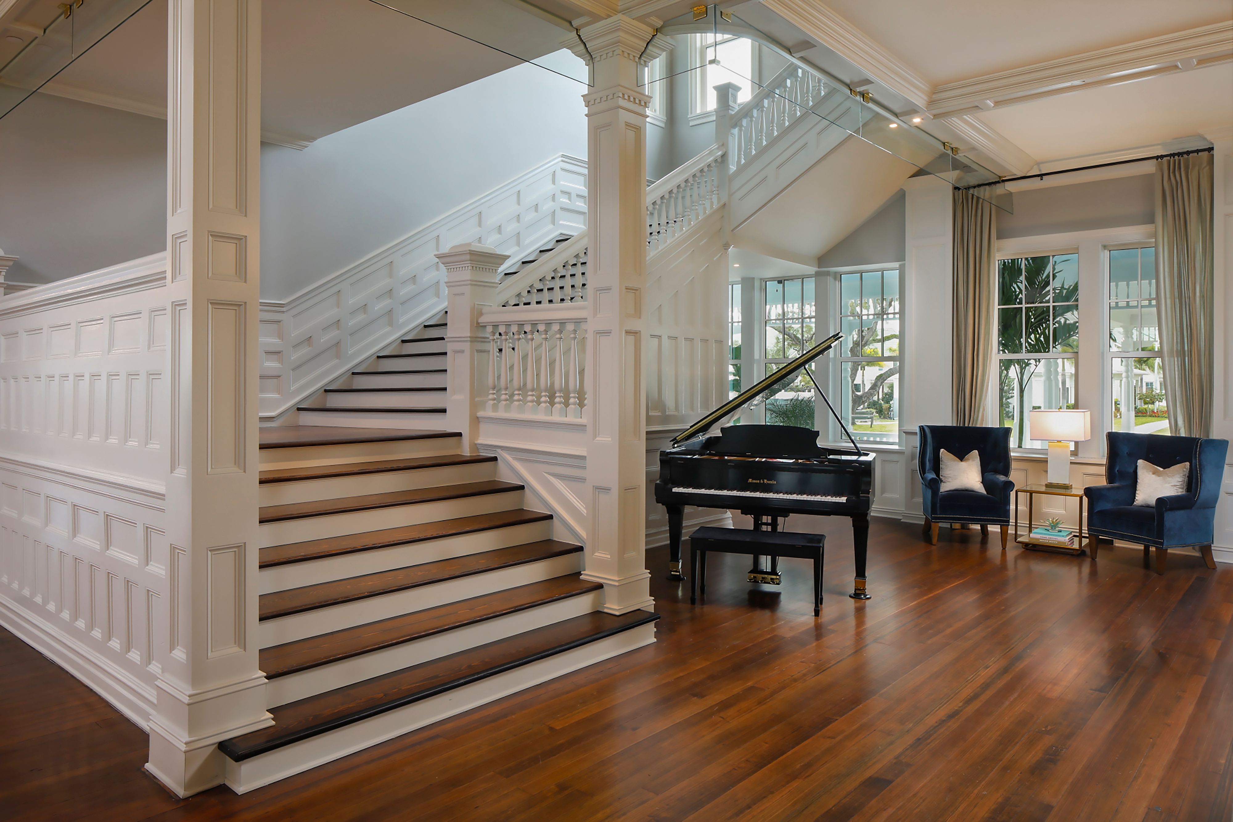 a piano in a room with stairs