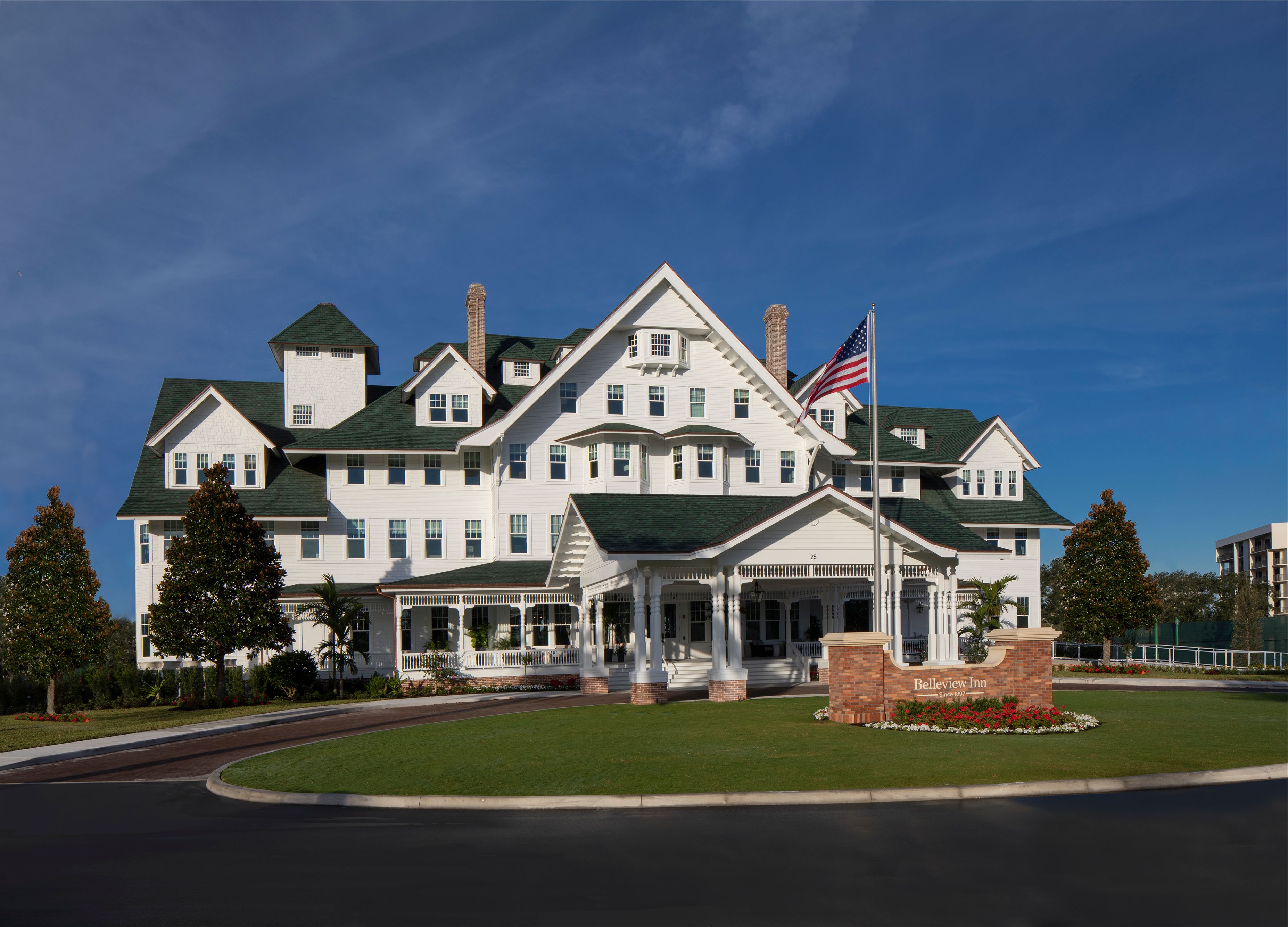 a large white house with a flag on the front
