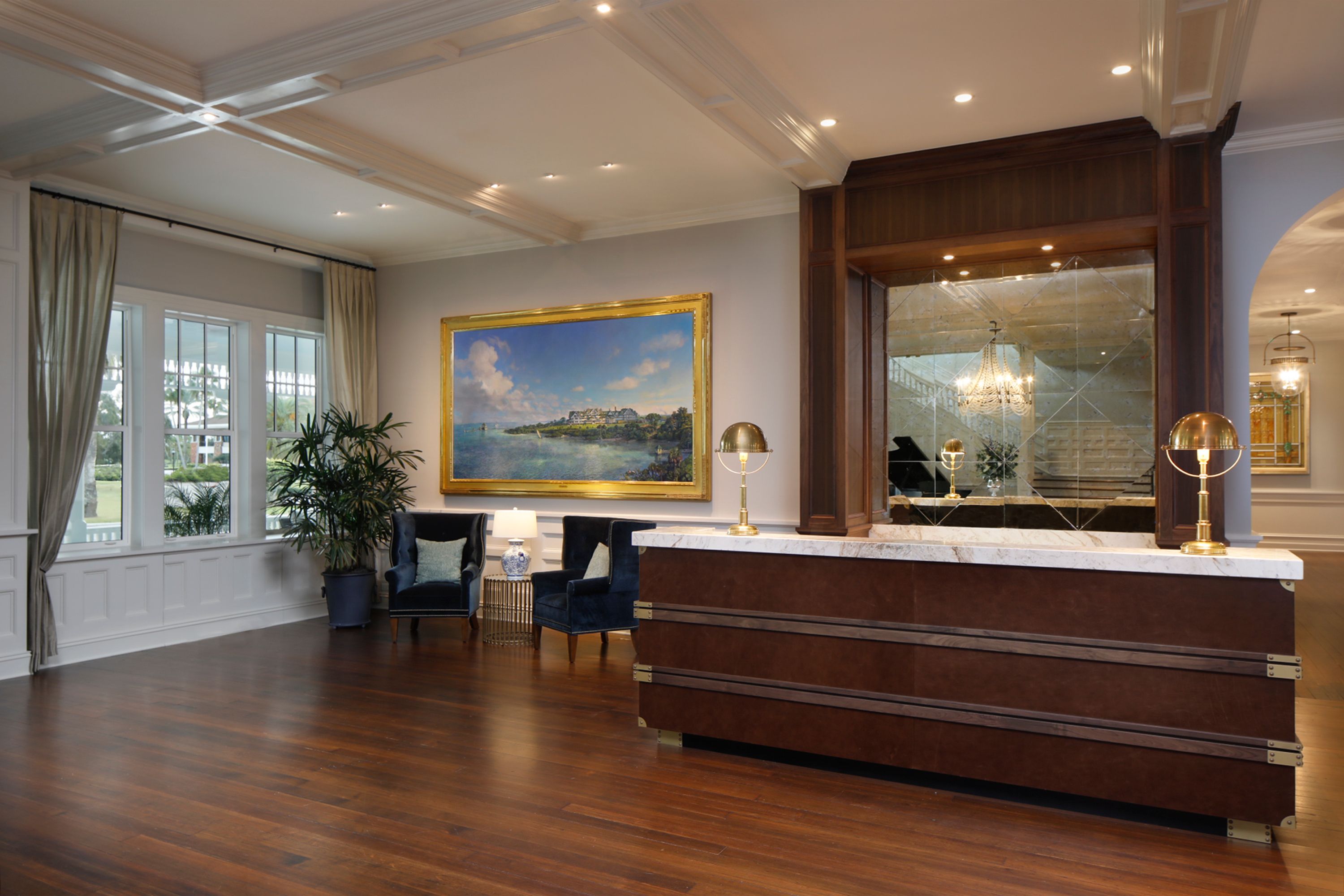 a lobby with a large painting on the wall