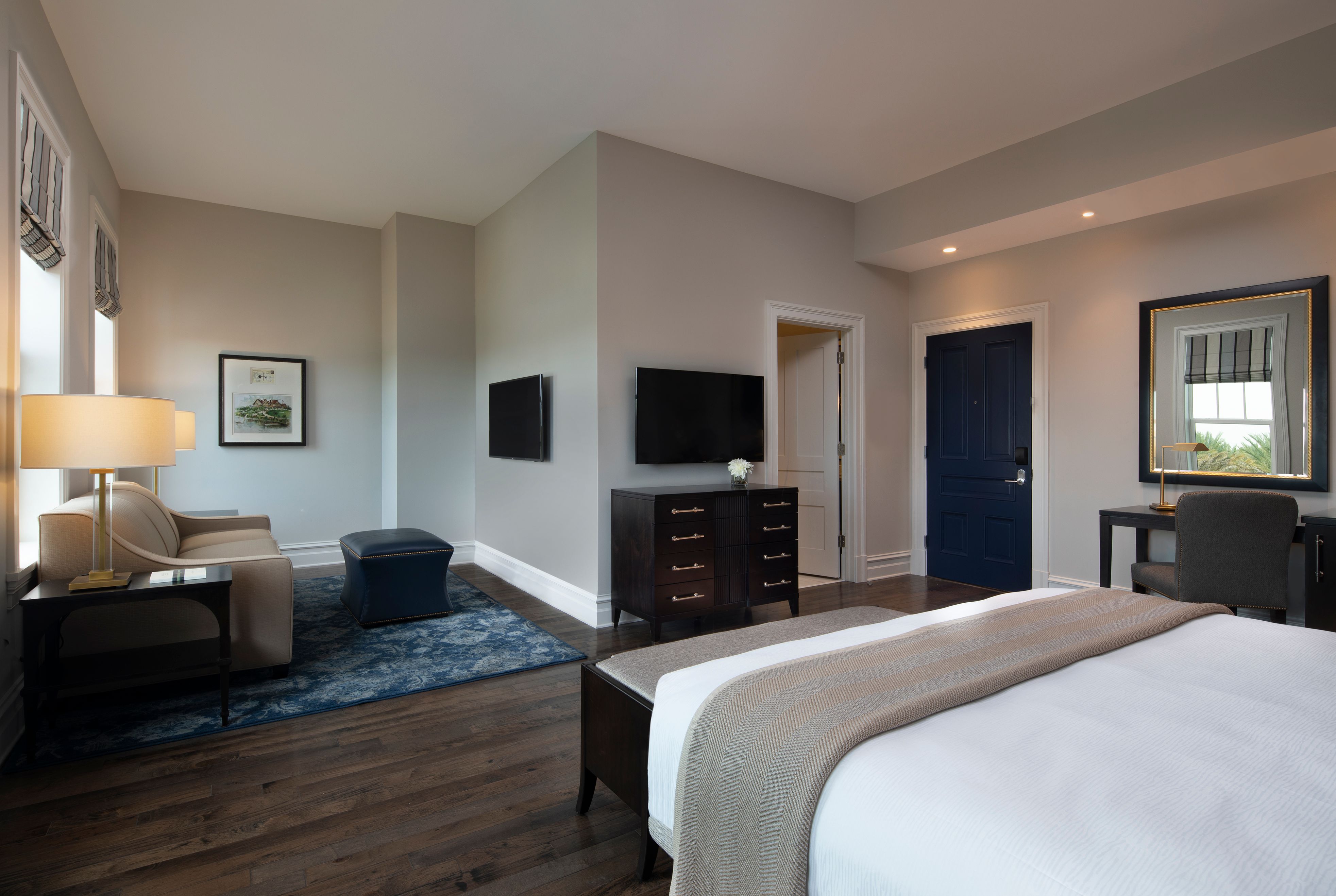 a bedroom with a tv and a couch