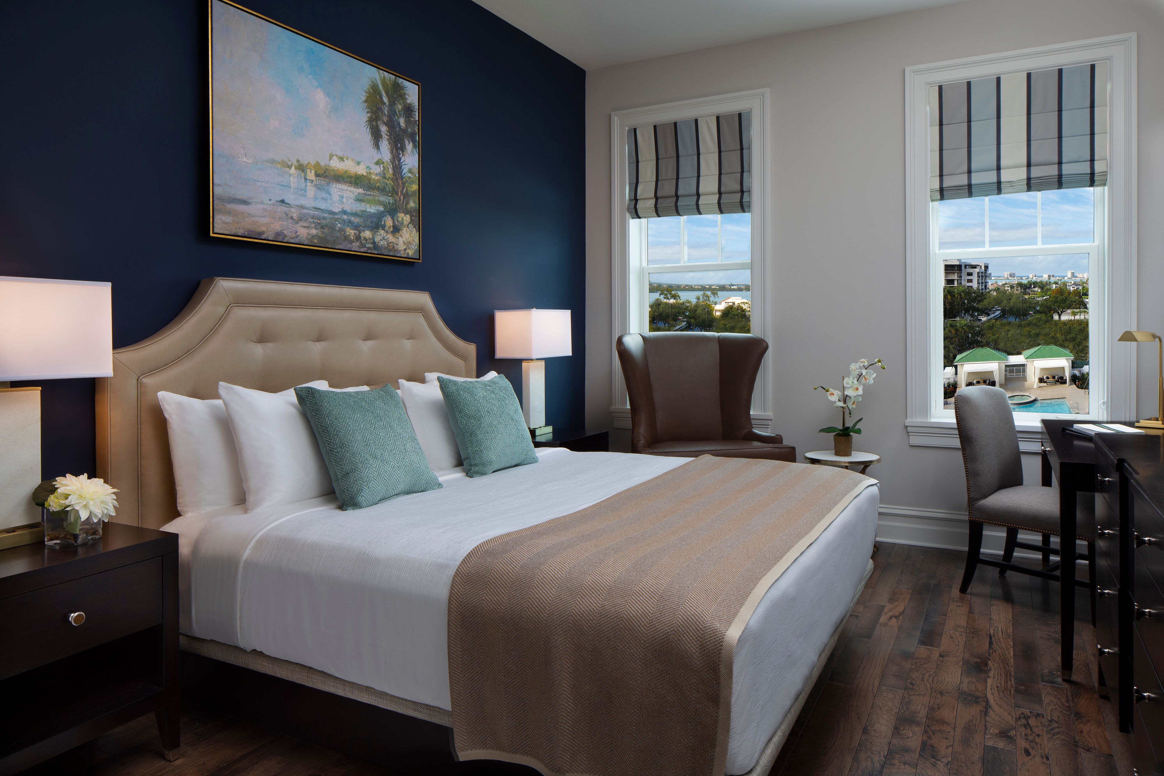 a bedroom with a bed and chairs