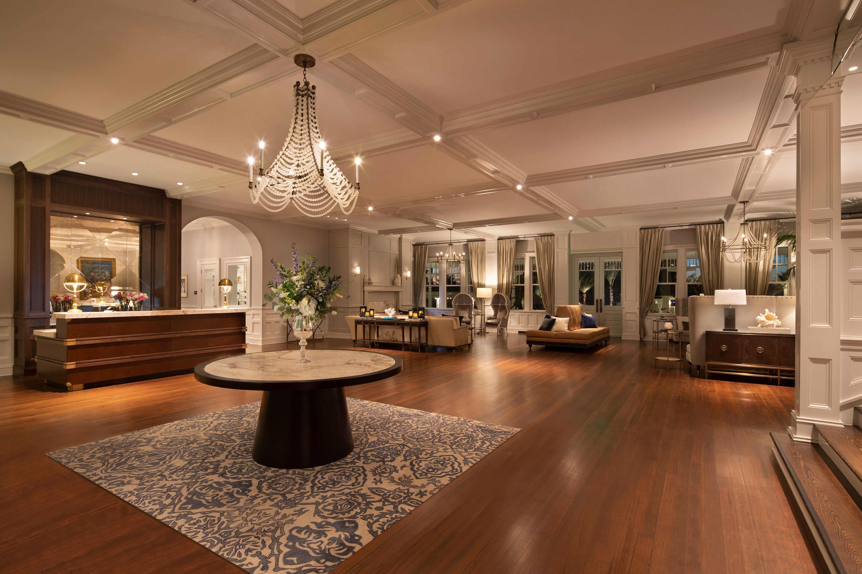 a room with a large table and chandelier