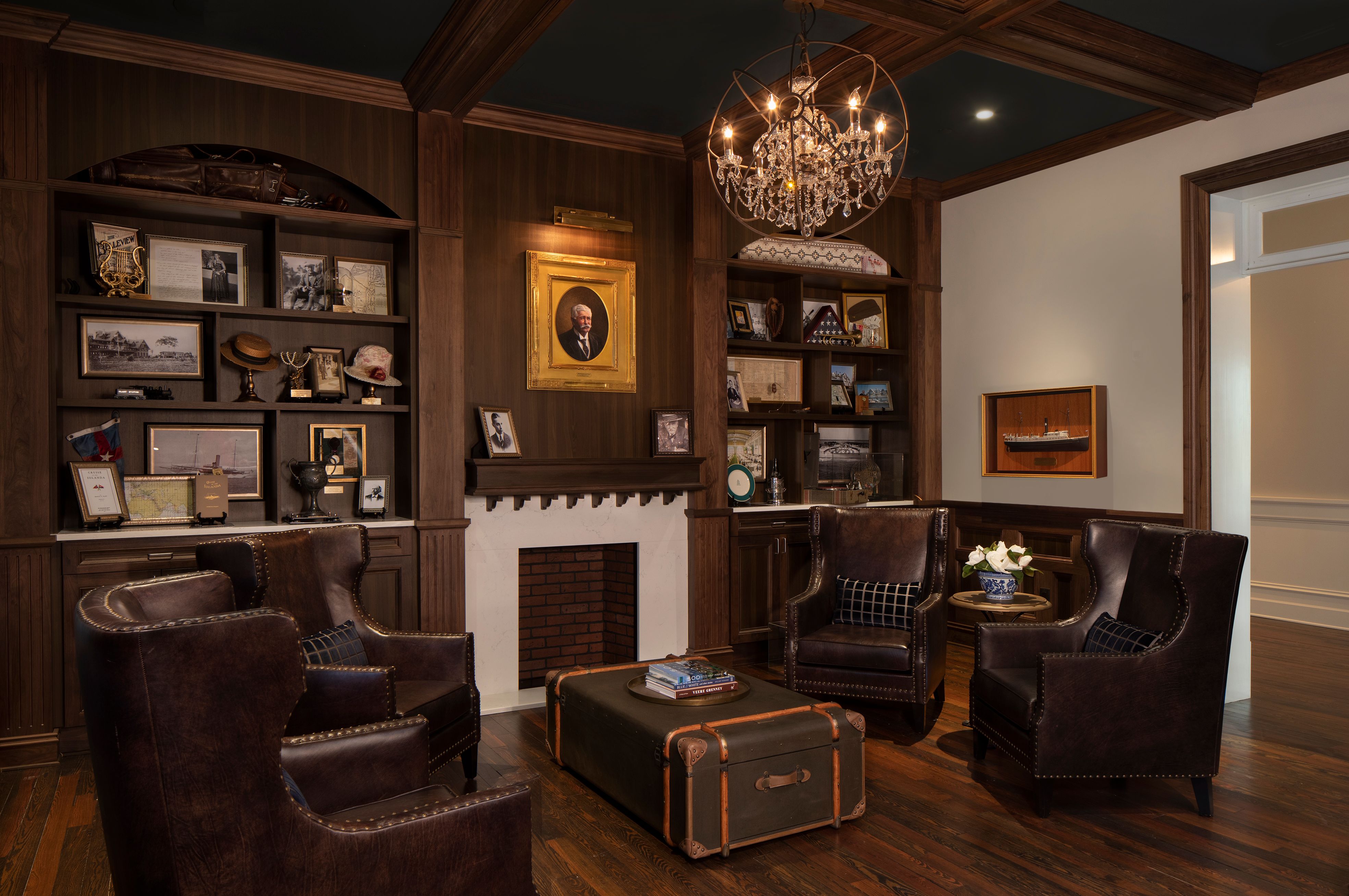 a room with a chandelier and a suitcase
