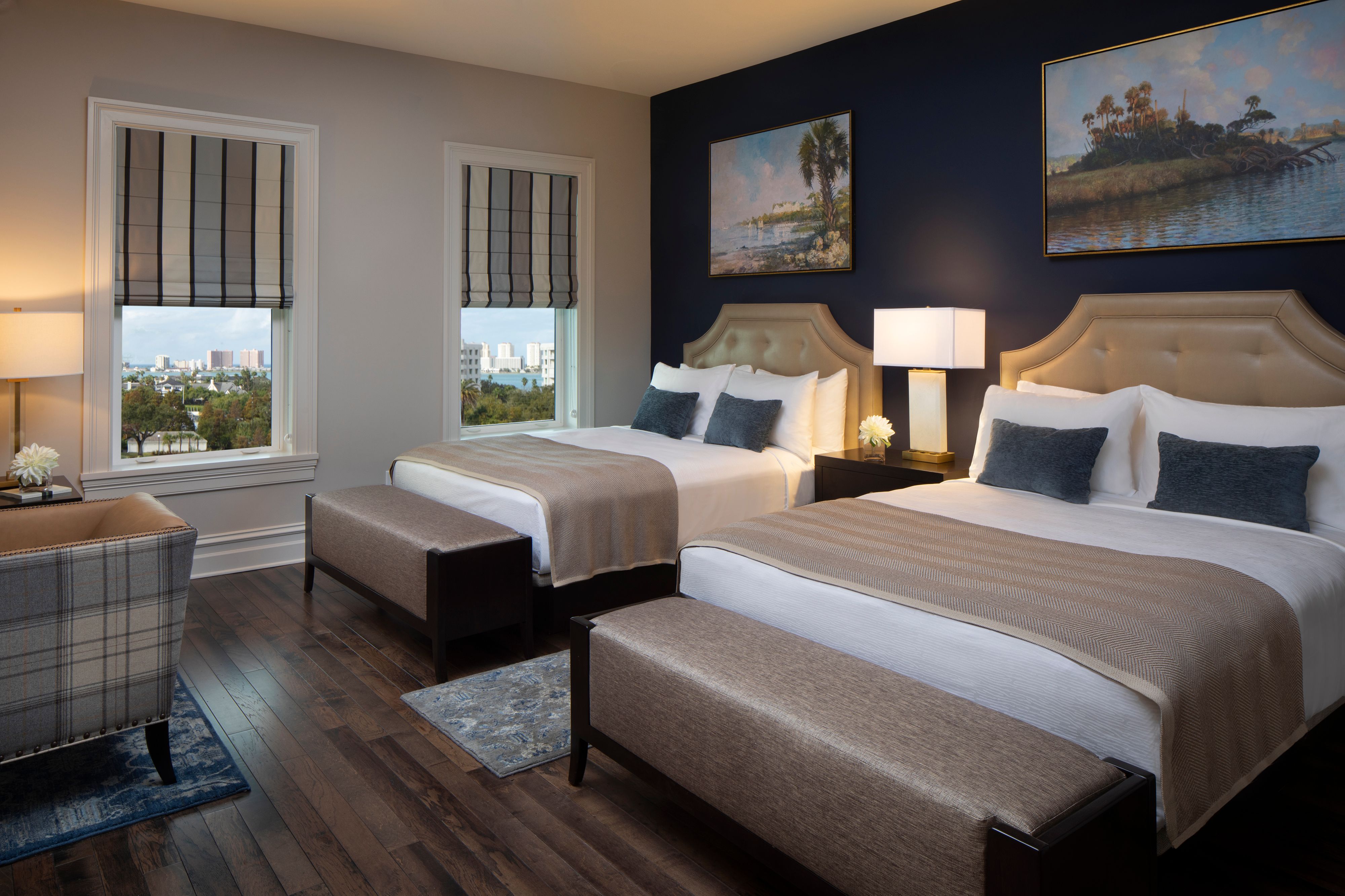 a room with two beds and a wood floor