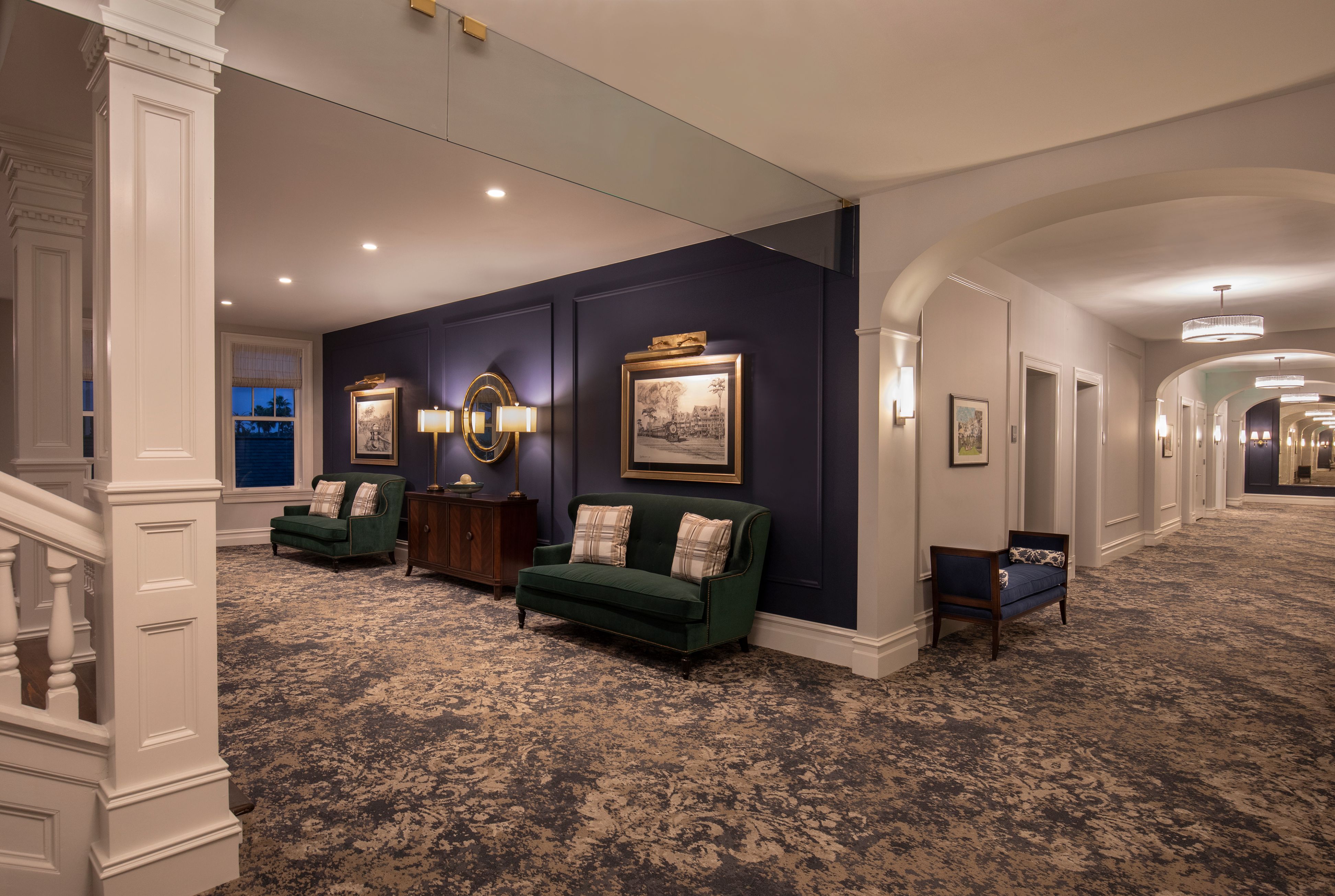 a room with a couch and chairs