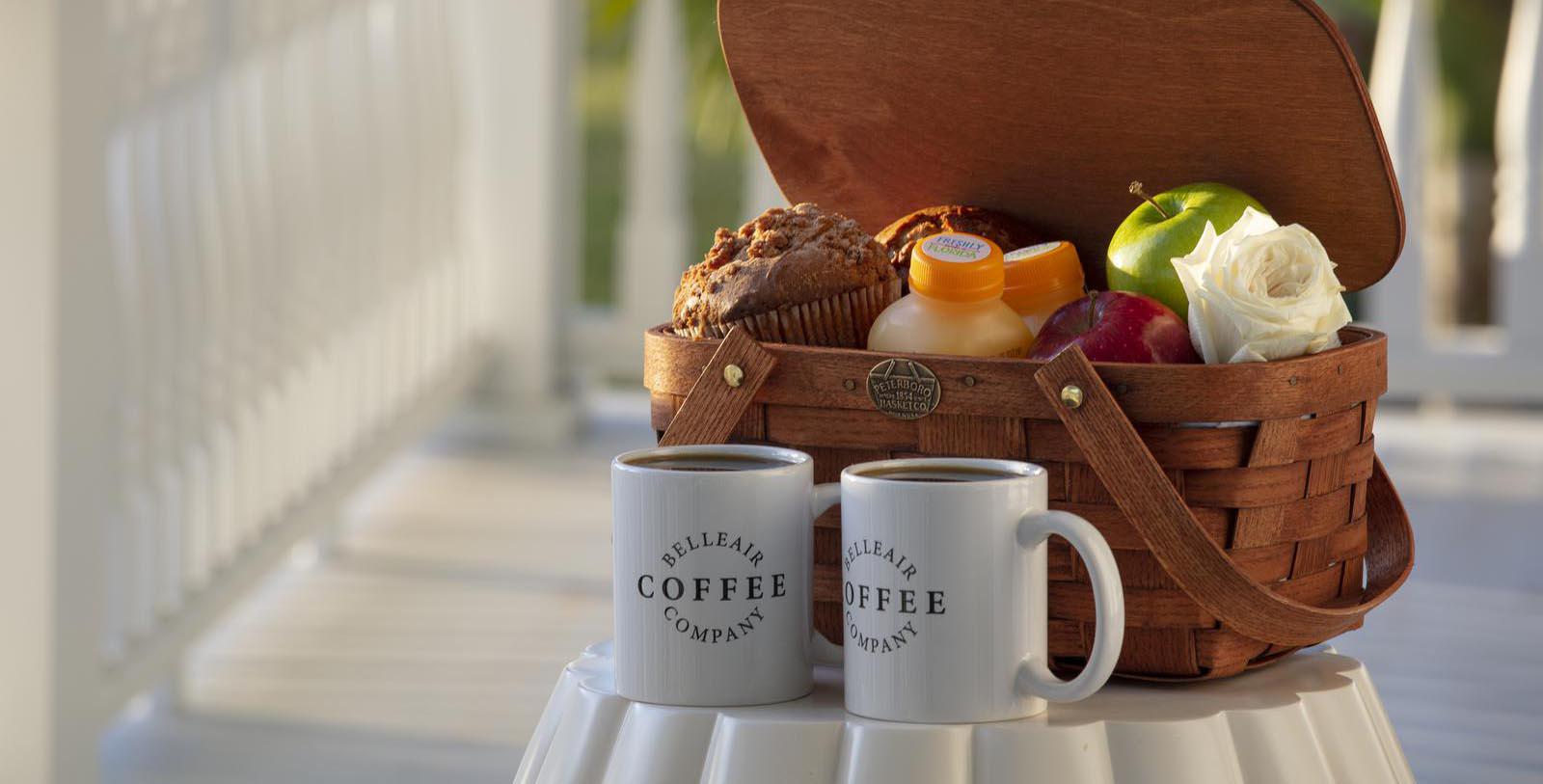 a basket with fruit and coffee cups