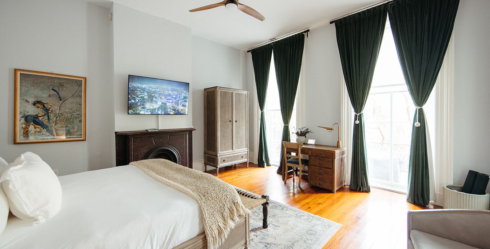 a bedroom with a tv and a fireplace