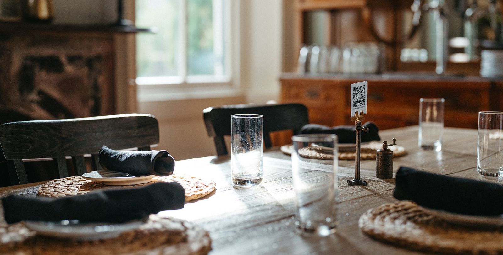 a table with glasses and napkins