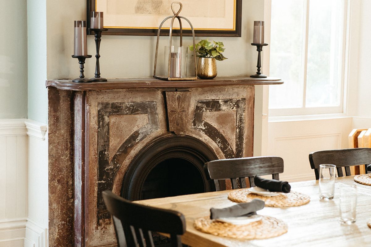 a table with chairs and a fireplace