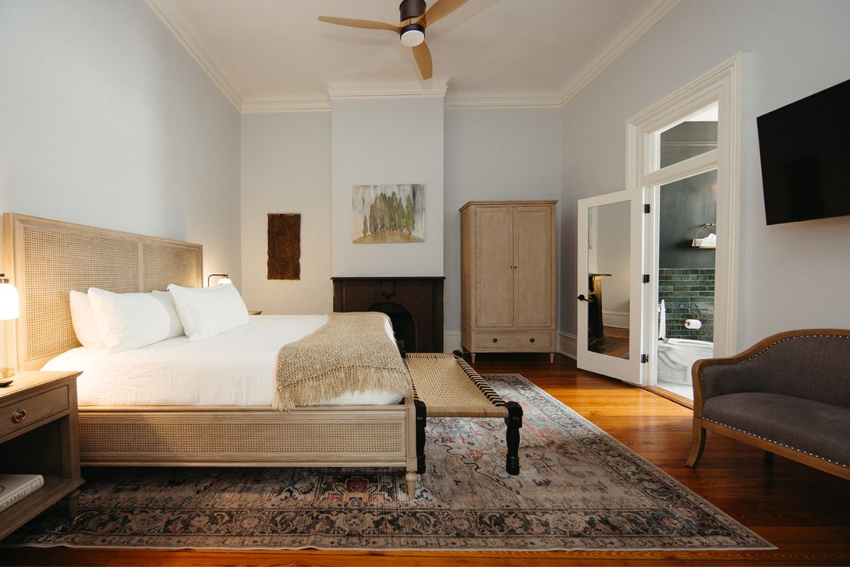 a bedroom with a bed and a rug