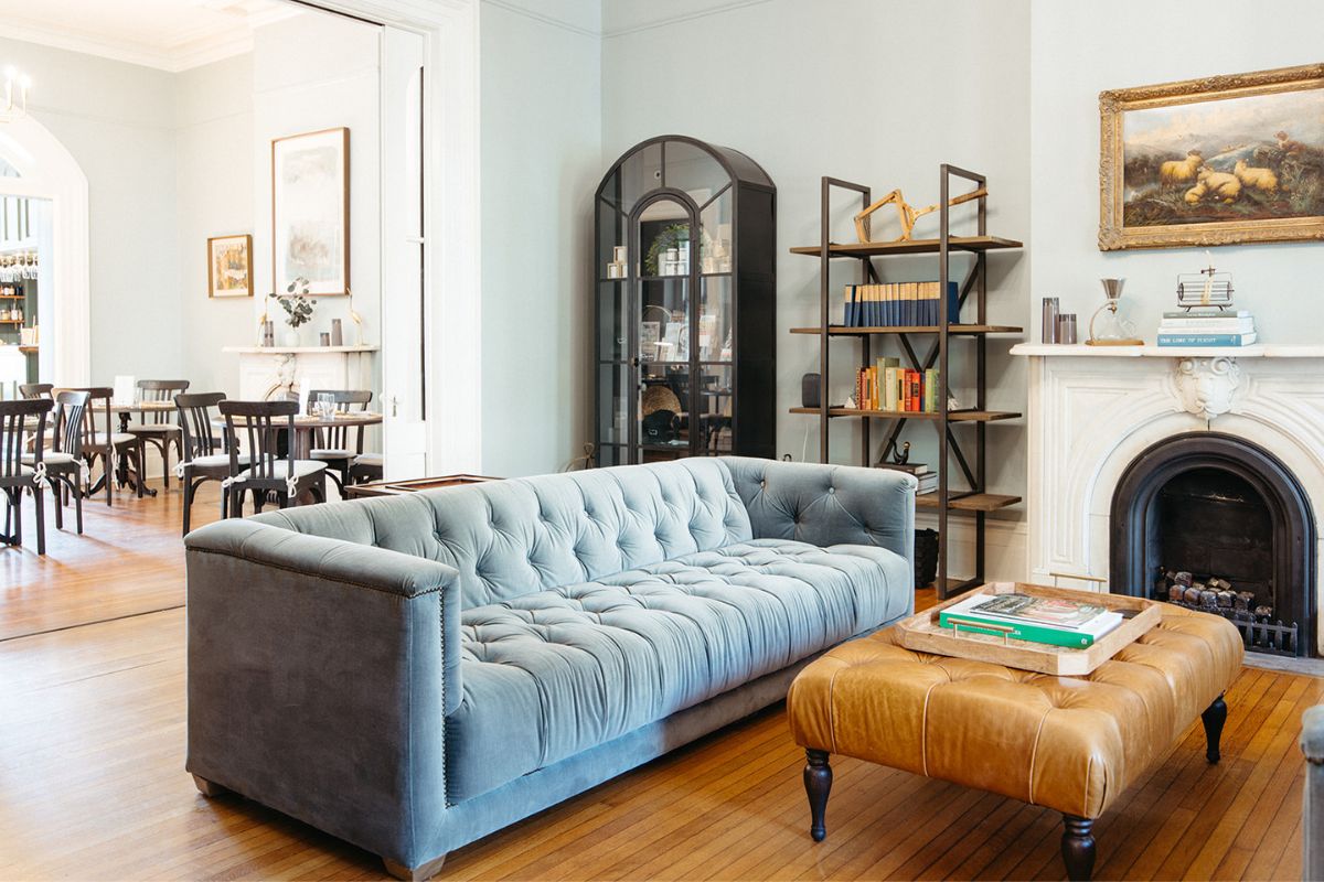 a living room with a couch and a leather ottoman