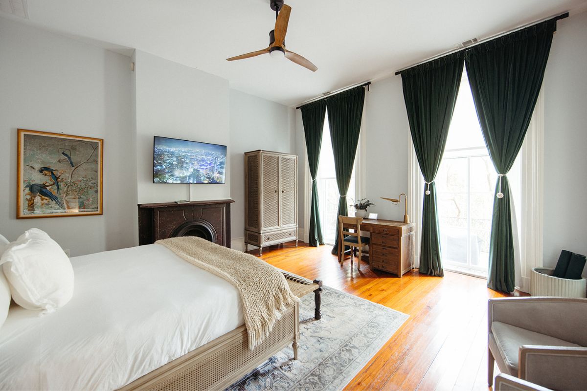 a bedroom with a fireplace and a tv