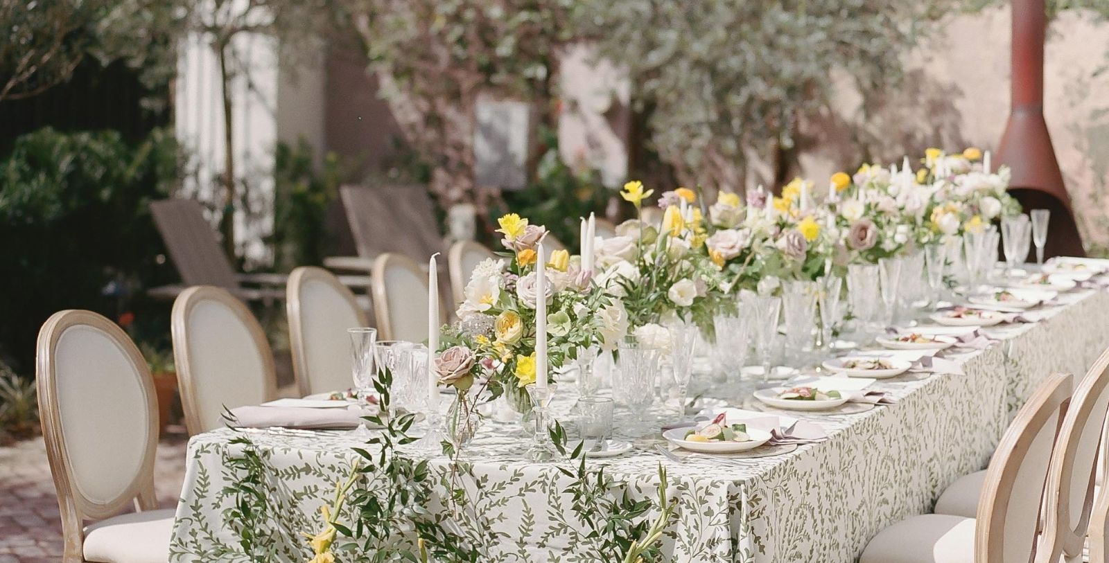 a table set with flowers and candles