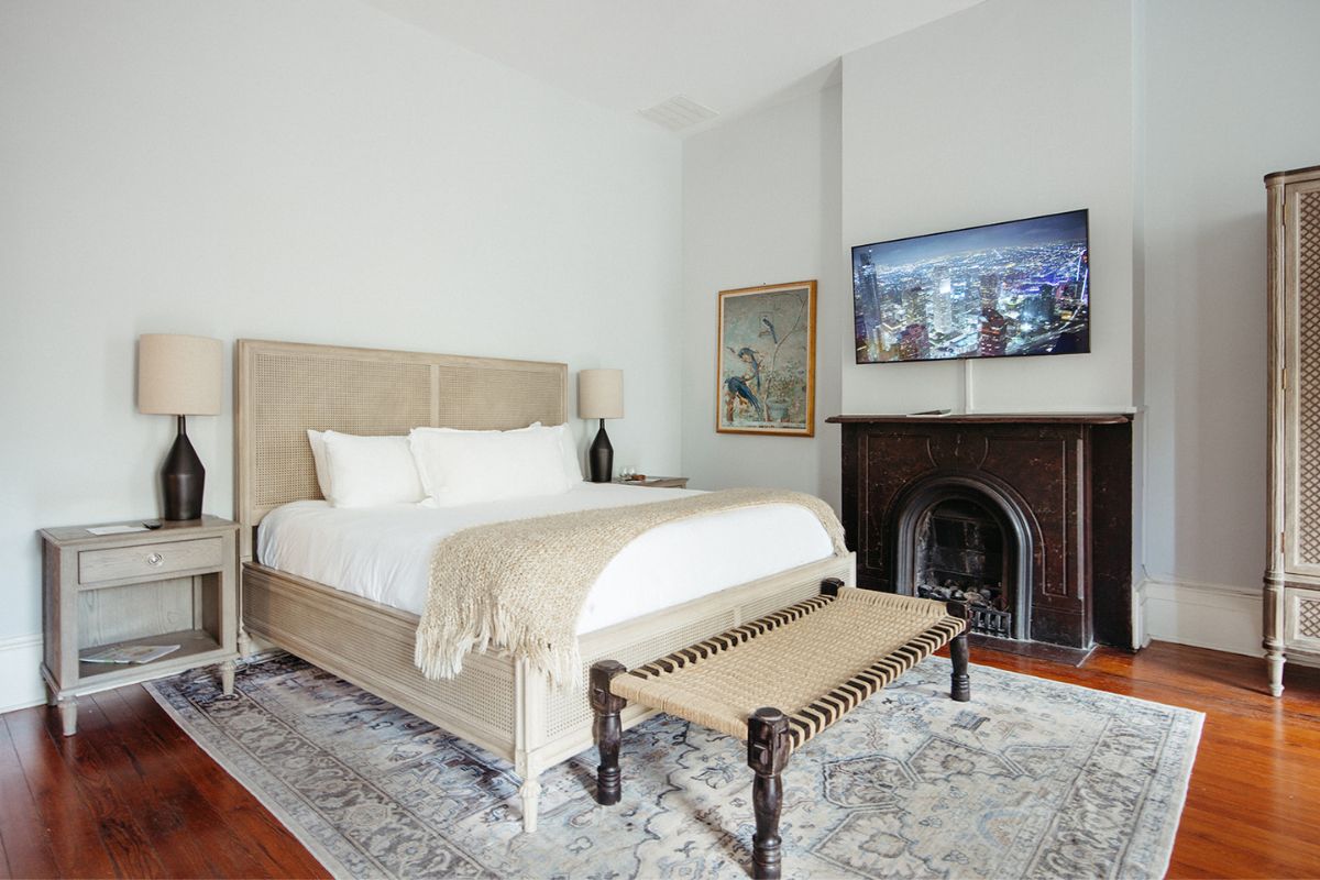 a bedroom with a fireplace and a bed