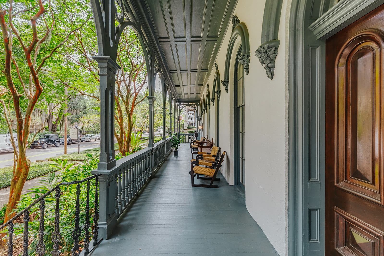 a porch with chairs and railings