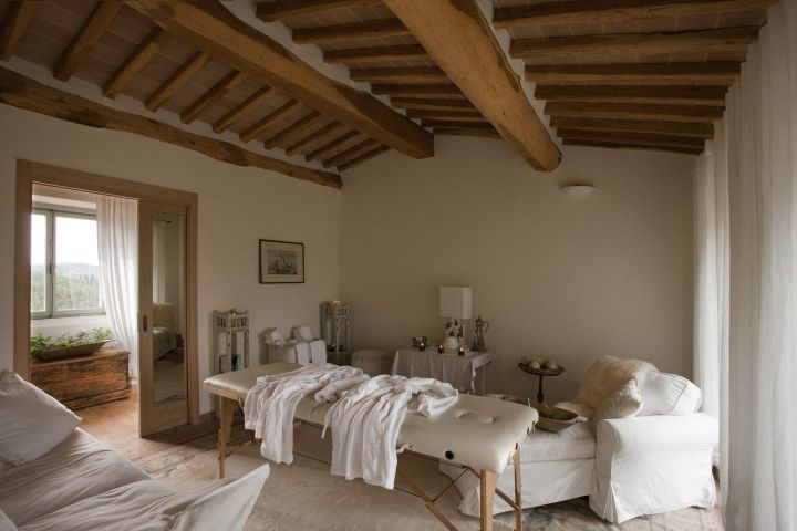 a room with a massage table and couches
