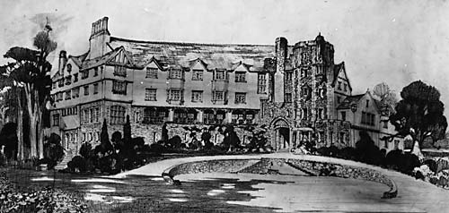 a large stone building with a pond