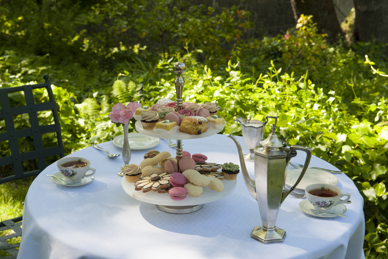 a table with a tray of food and teapots