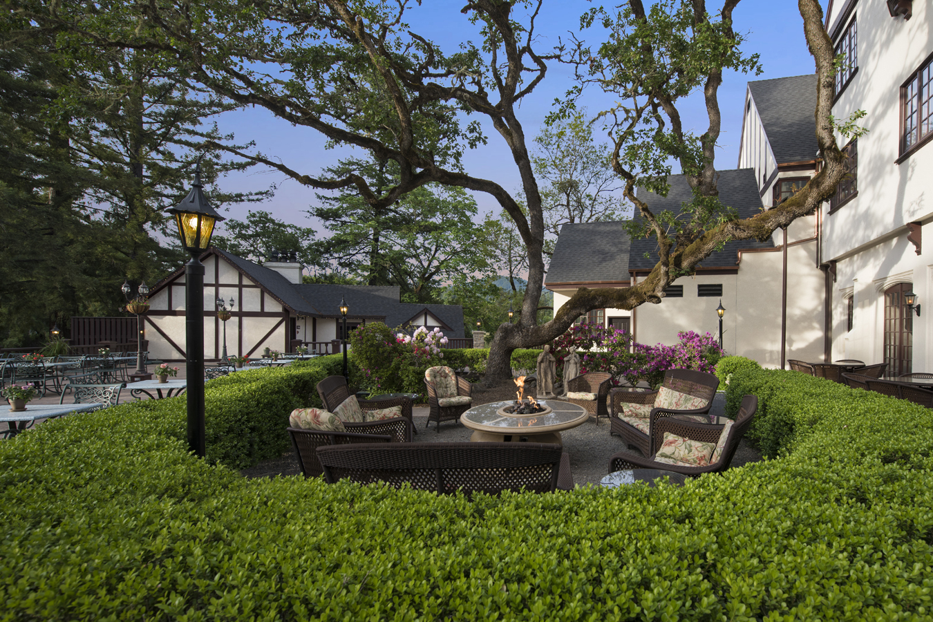 a patio area with a fire pit and a house