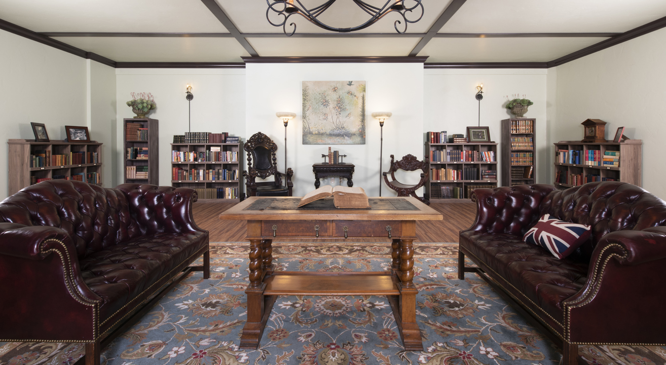 a room with a book and leather chairs