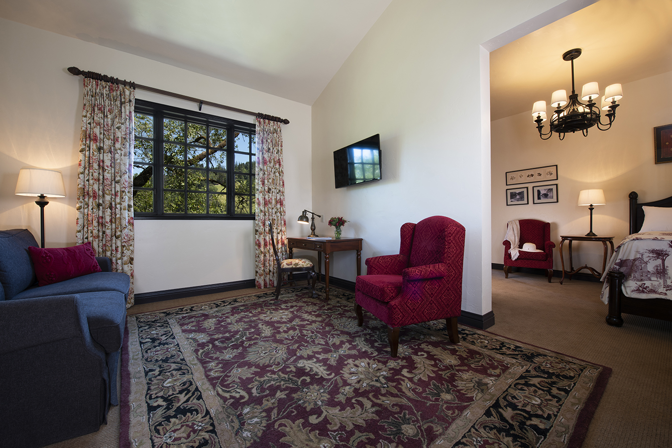 a living room with a red chair and a rug