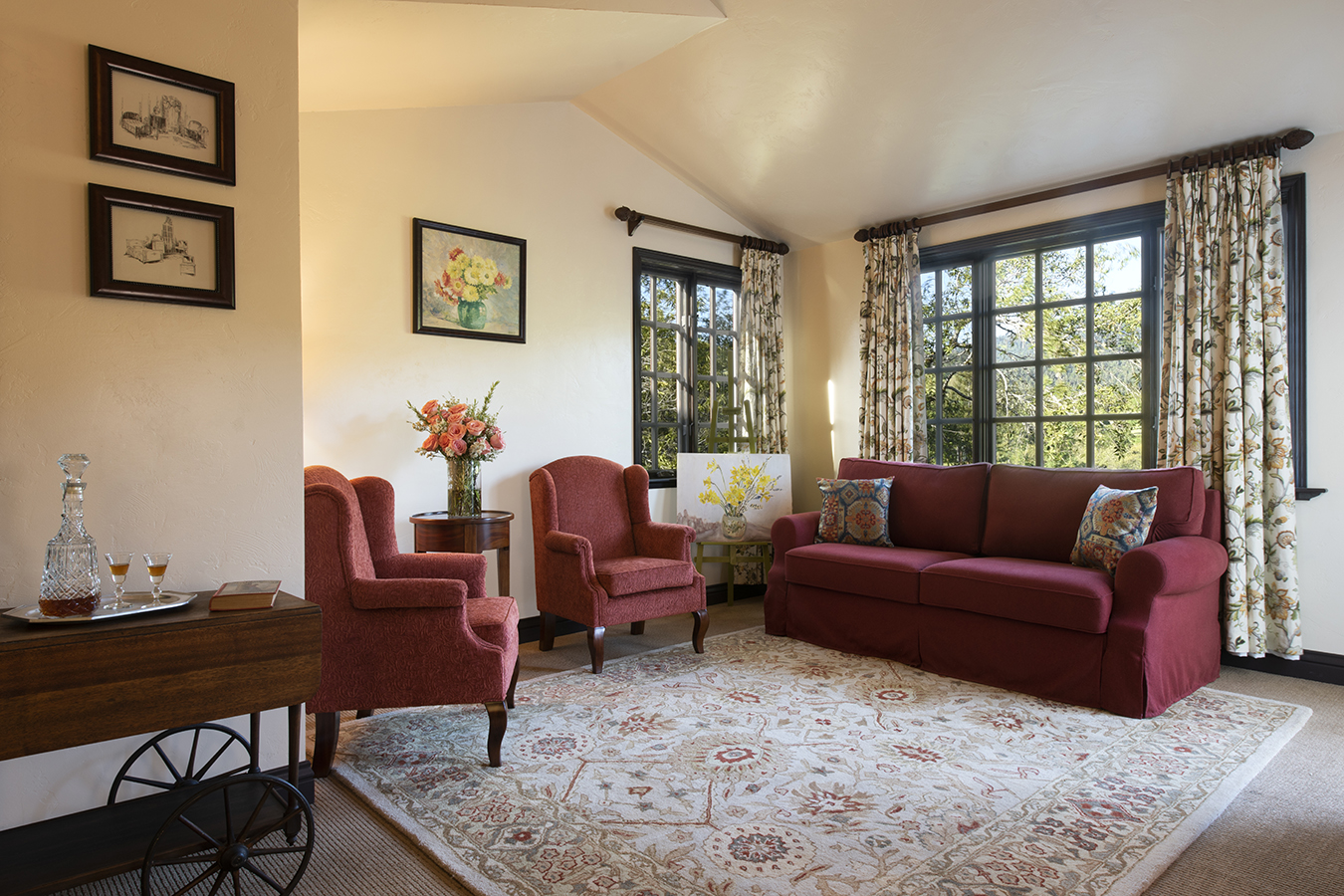 a living room with a red couch and chairs