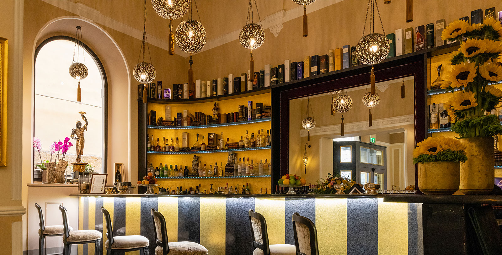 a bar with shelves and lights