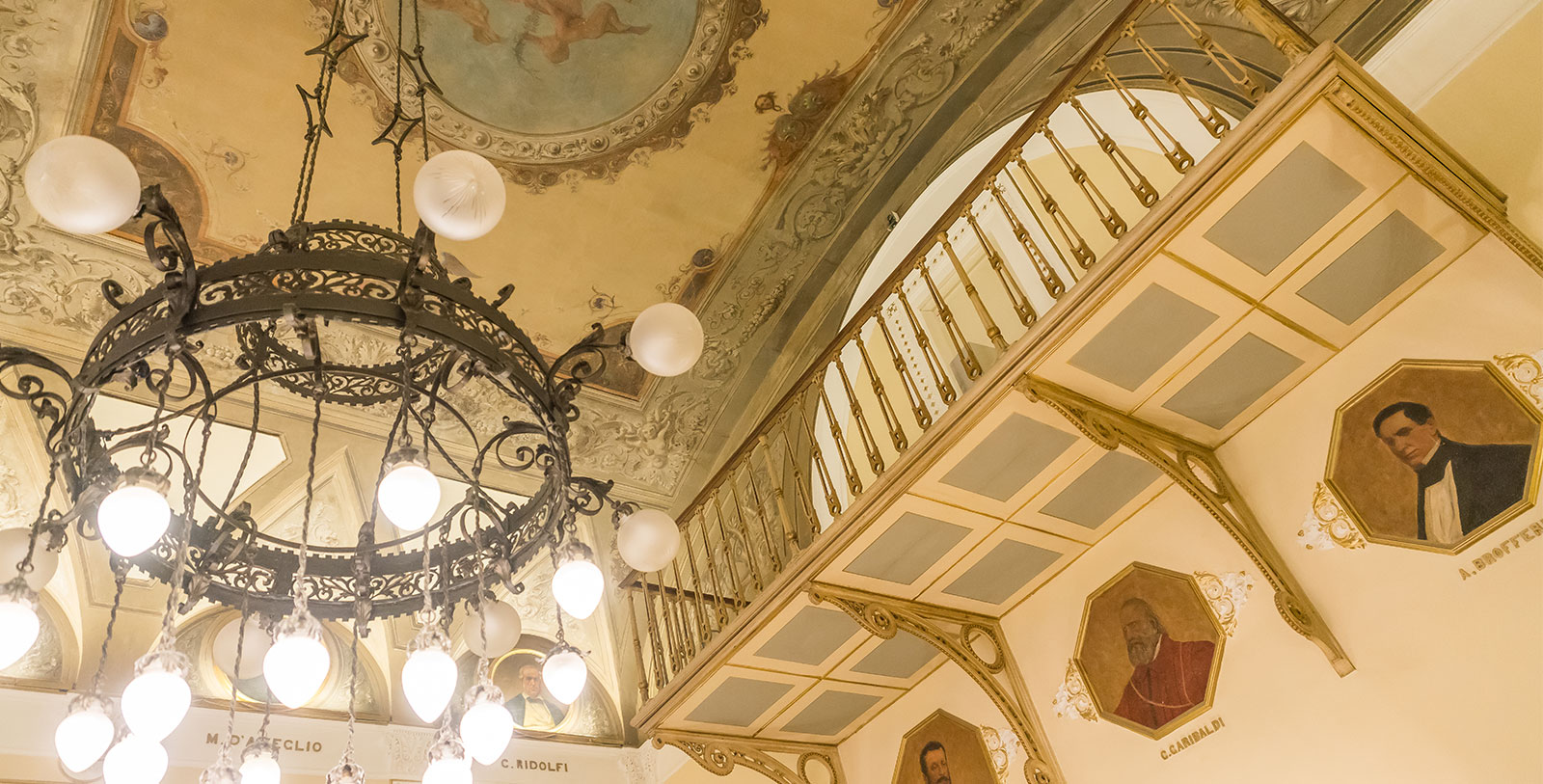 a chandelier and a balcony with a railing