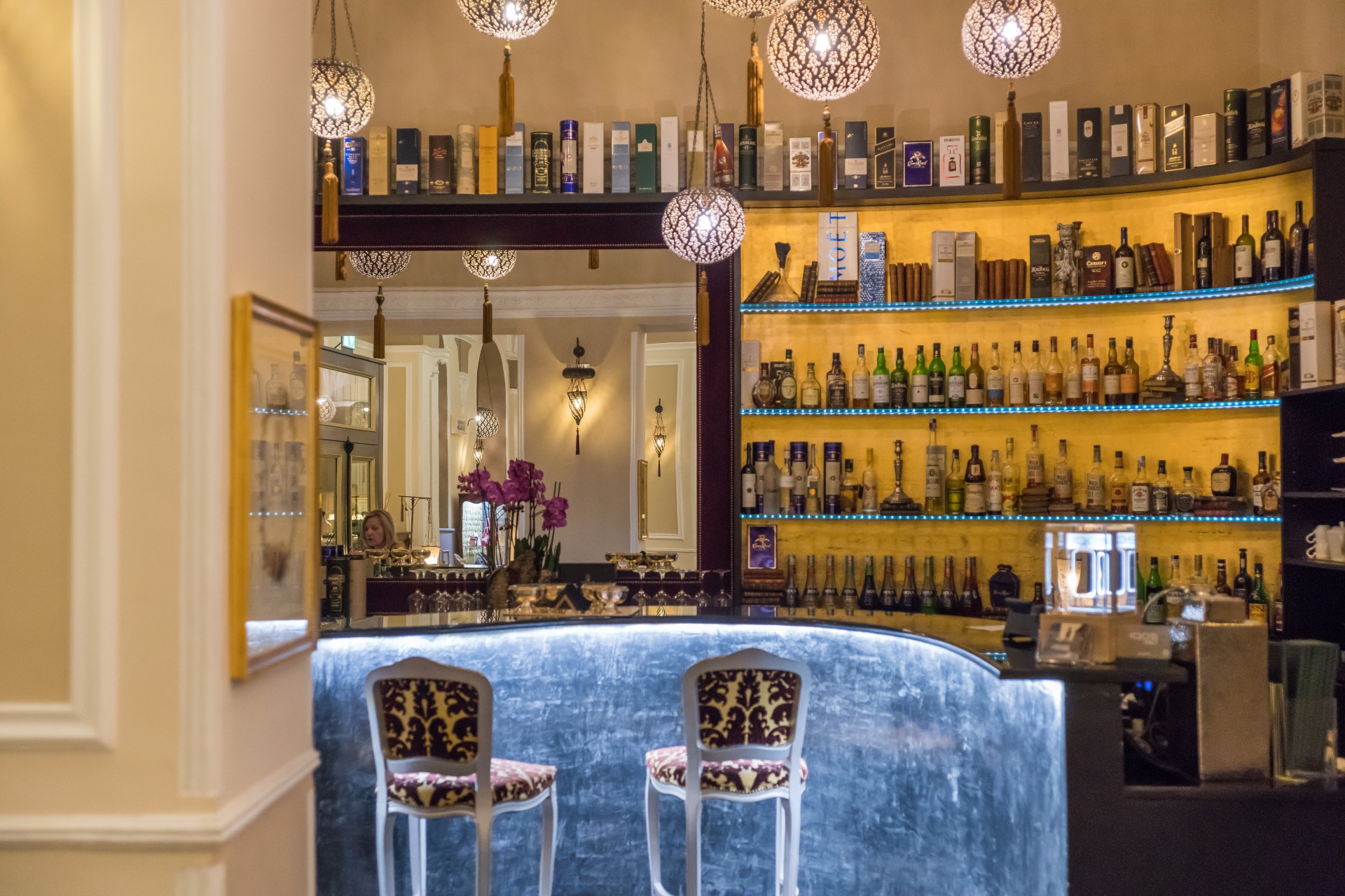 a bar with a bar and shelves of liquor