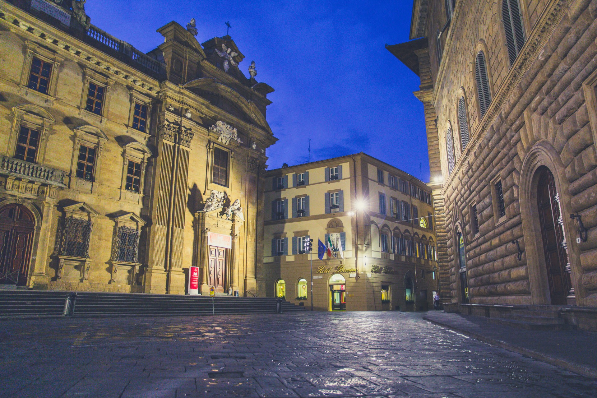 a stone walkway between two buildings