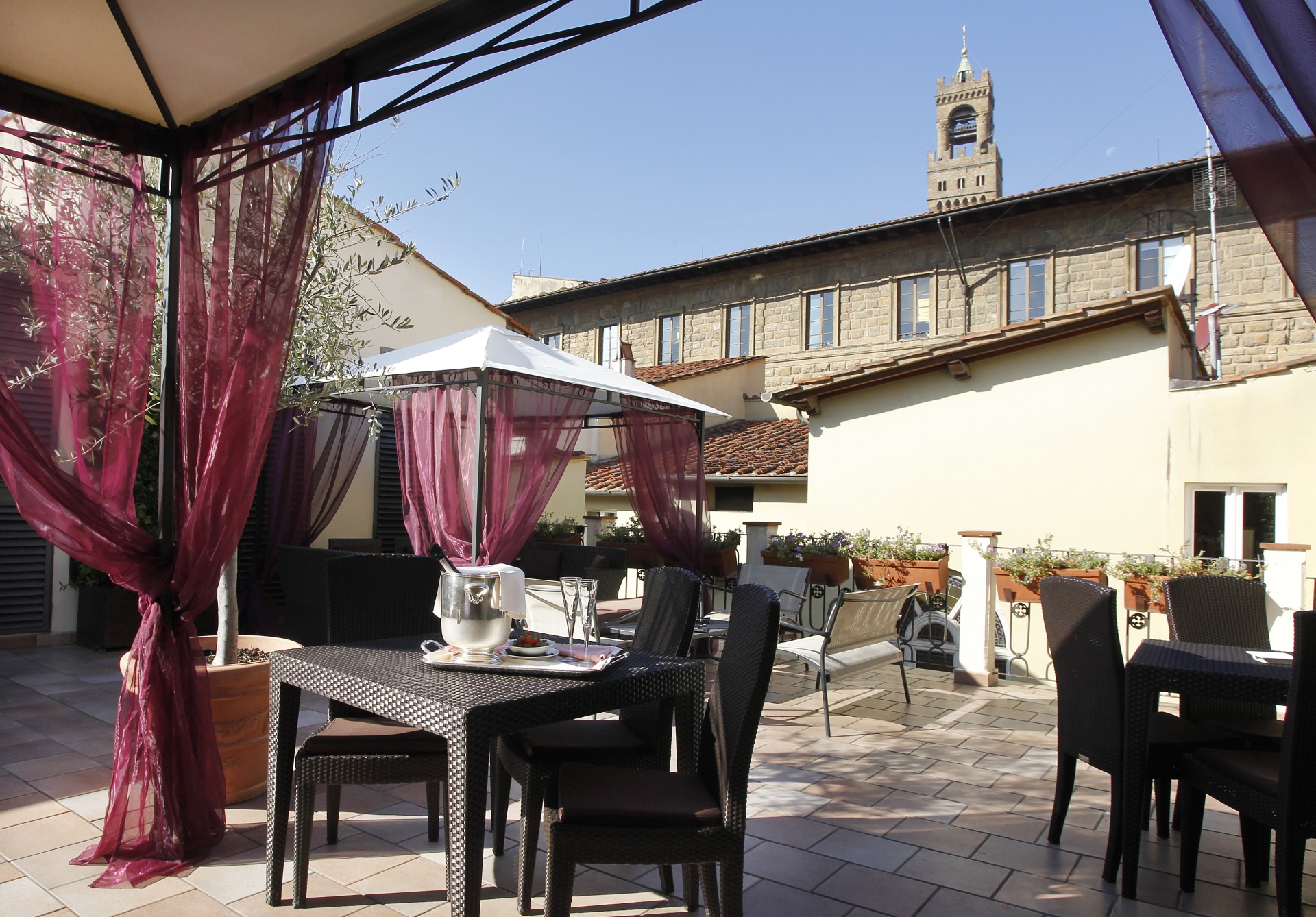 a patio with chairs and tables