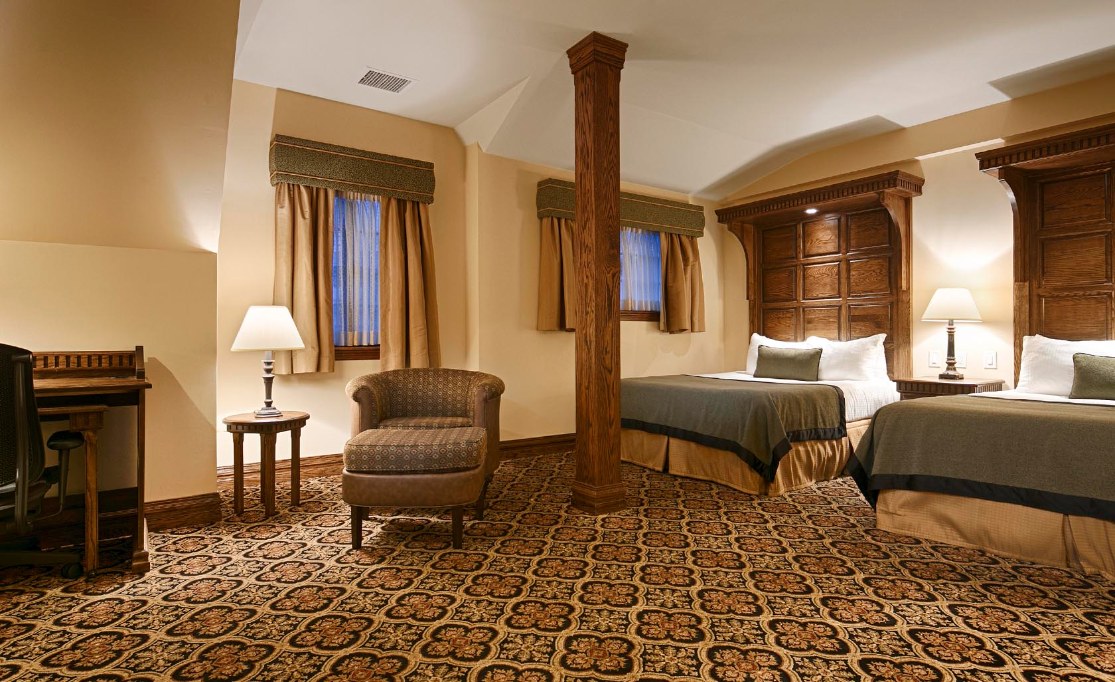 a room with two beds and a chair