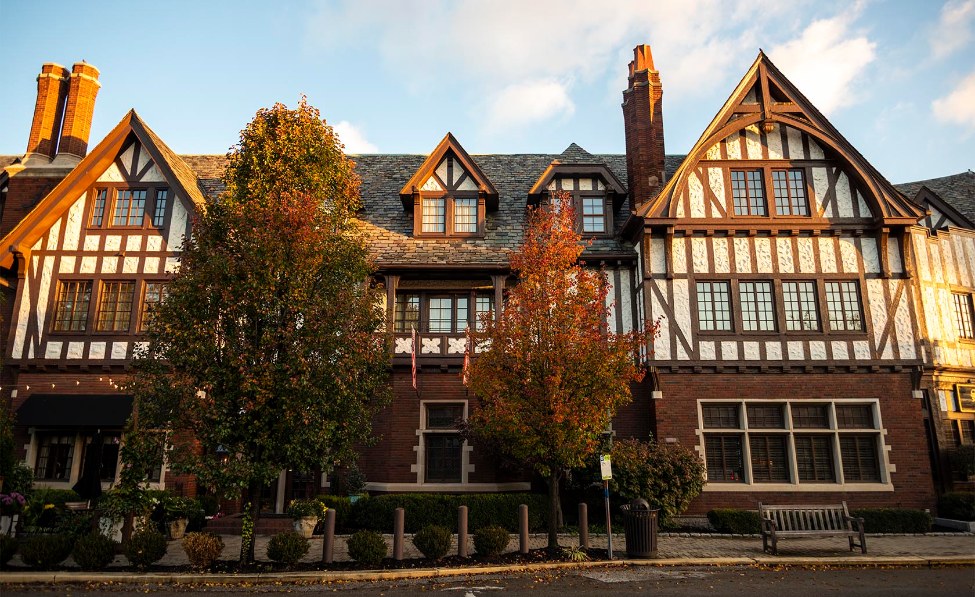a large brick building with trees in front of it