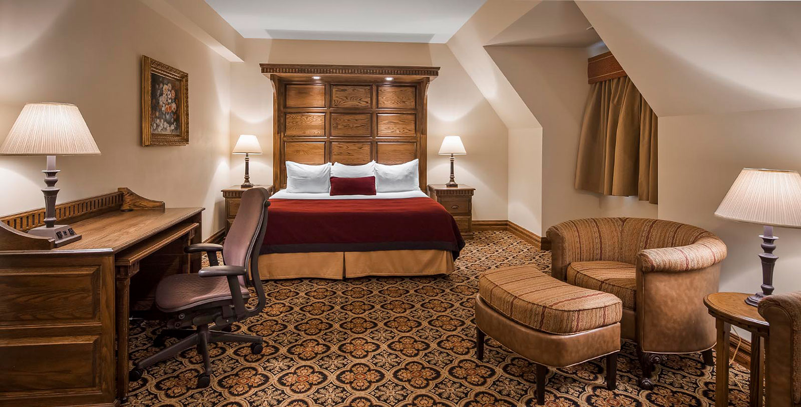 a room with a bed and chairs