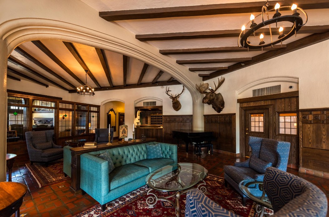 a room with a piano and couches