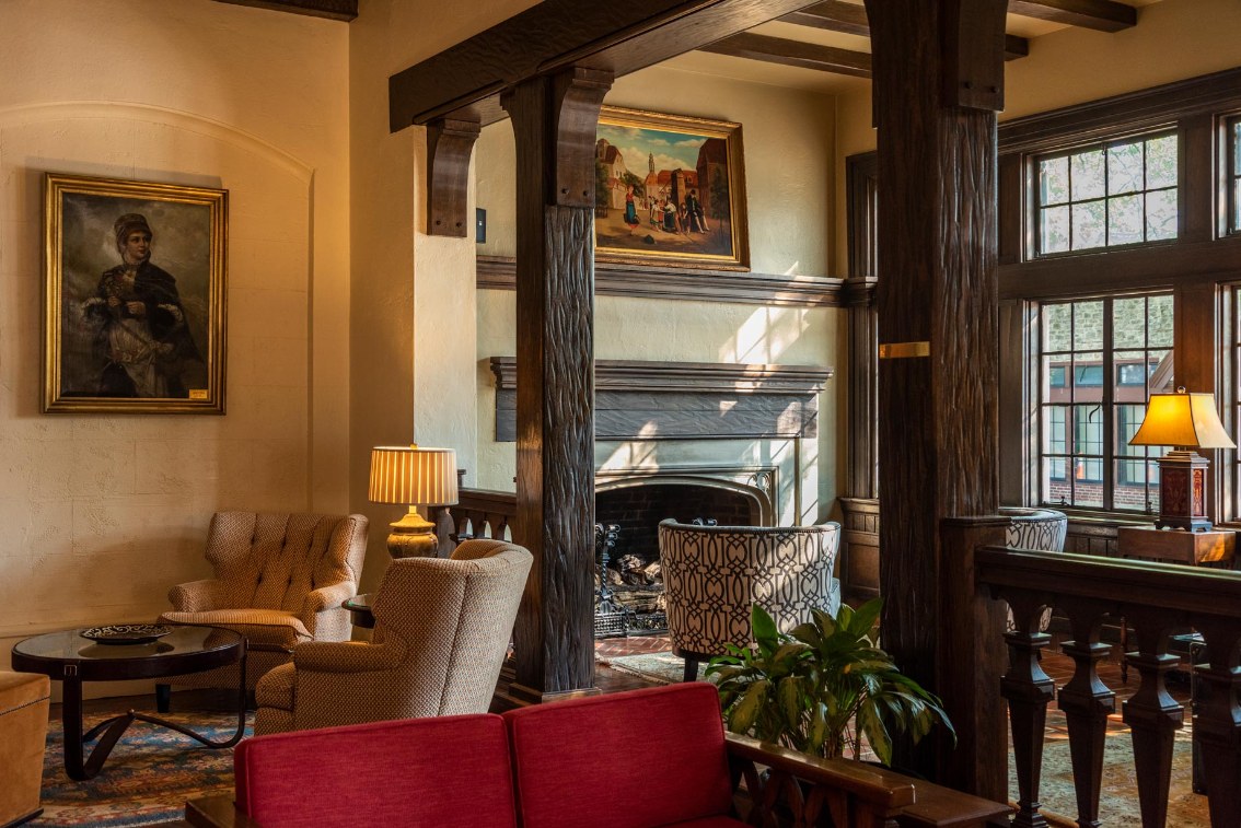 a room with a fireplace and chairs