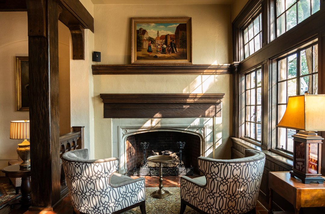 a room with two chairs and a fireplace
