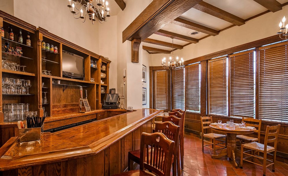 a room with a bar and a table