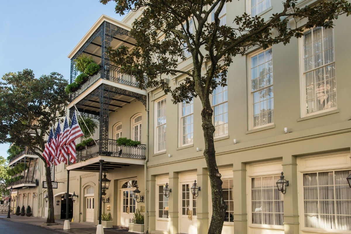 a building with flags on the balcony