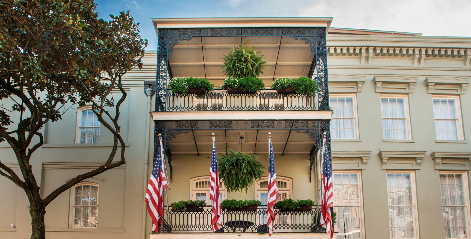 a balcony with flags and plants