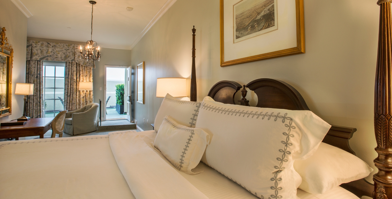 a bed with a lamp and a picture on the wall