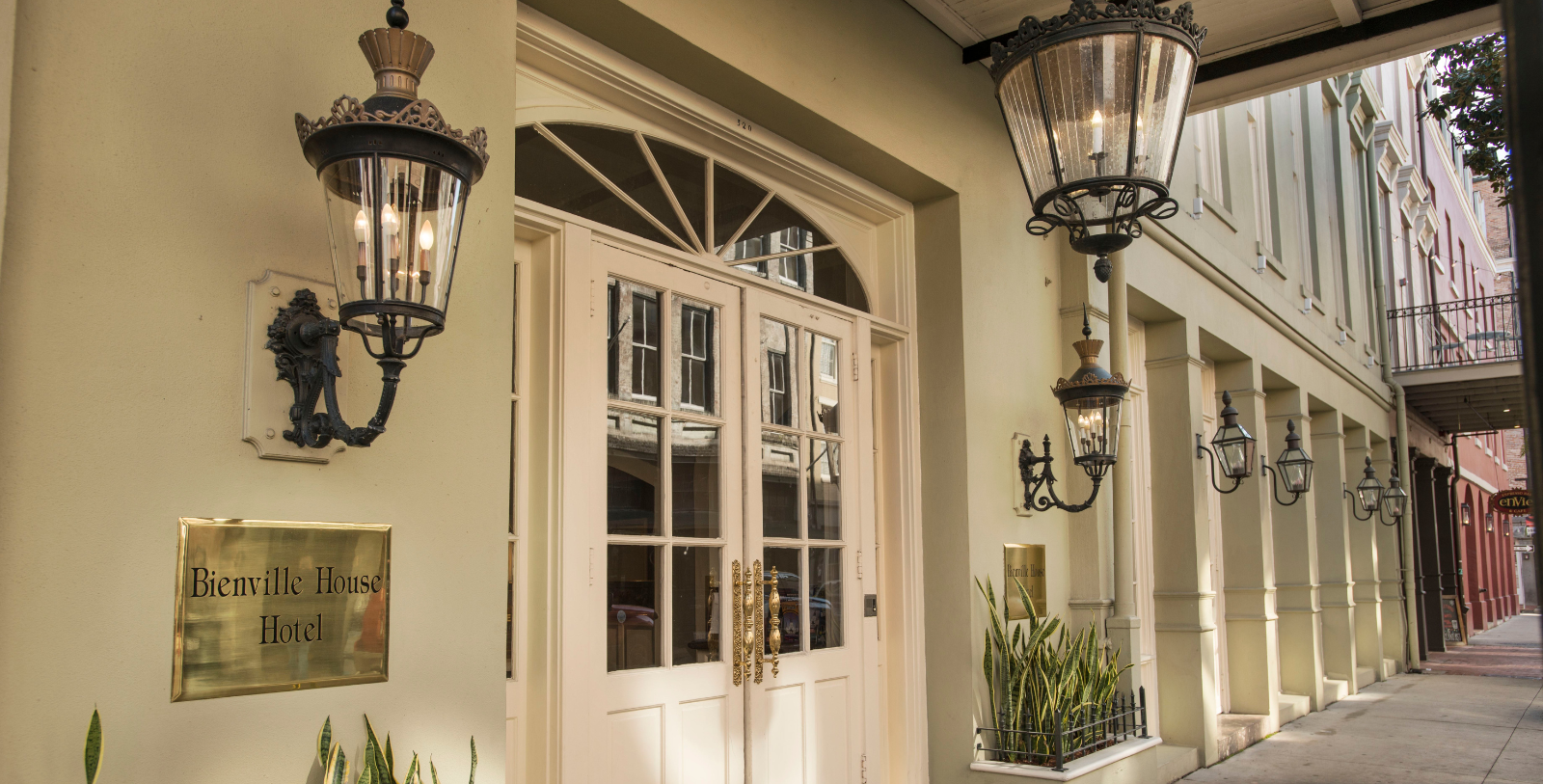 a white door with glass windows and a couple of lanterns