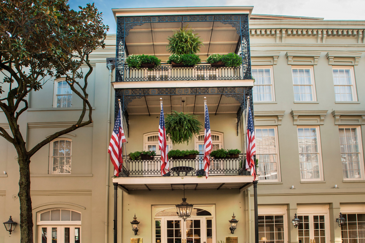 a building with flags and plants