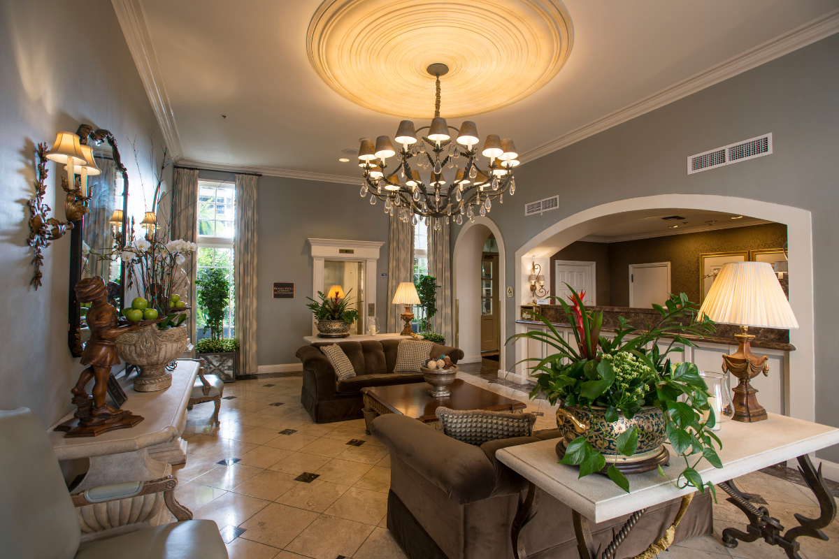 a living room with a chandelier and couches
