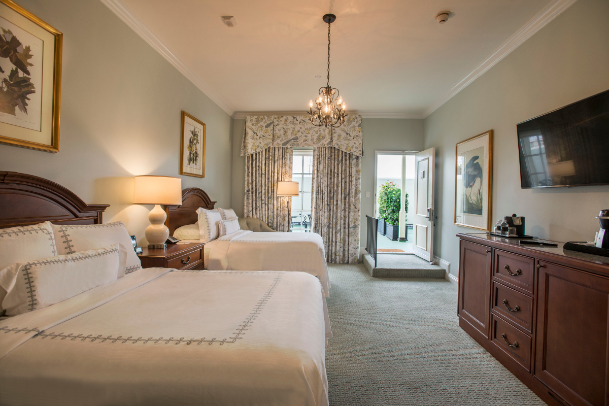 a room with two beds and a chandelier