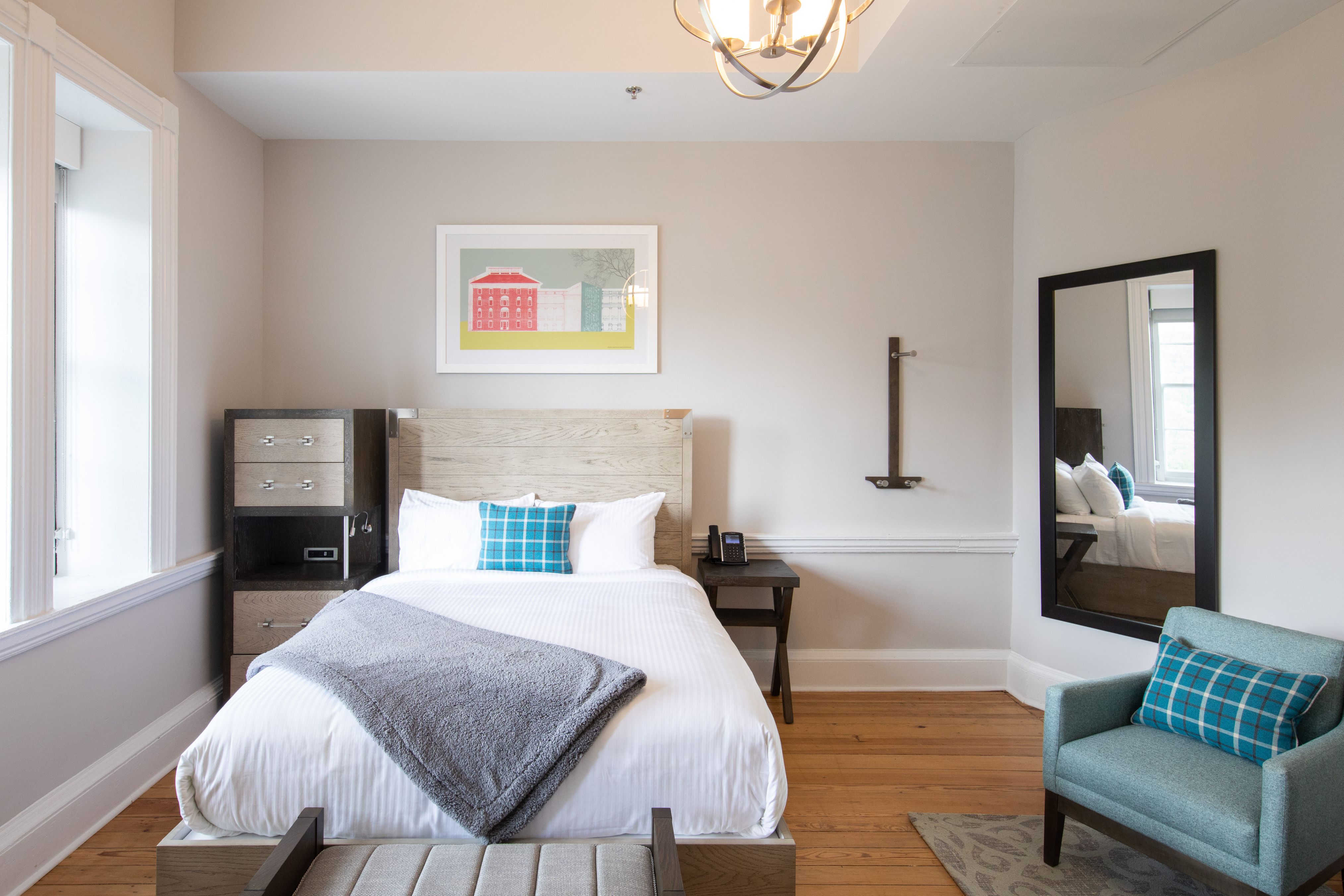 a bedroom with a bed and a mirror